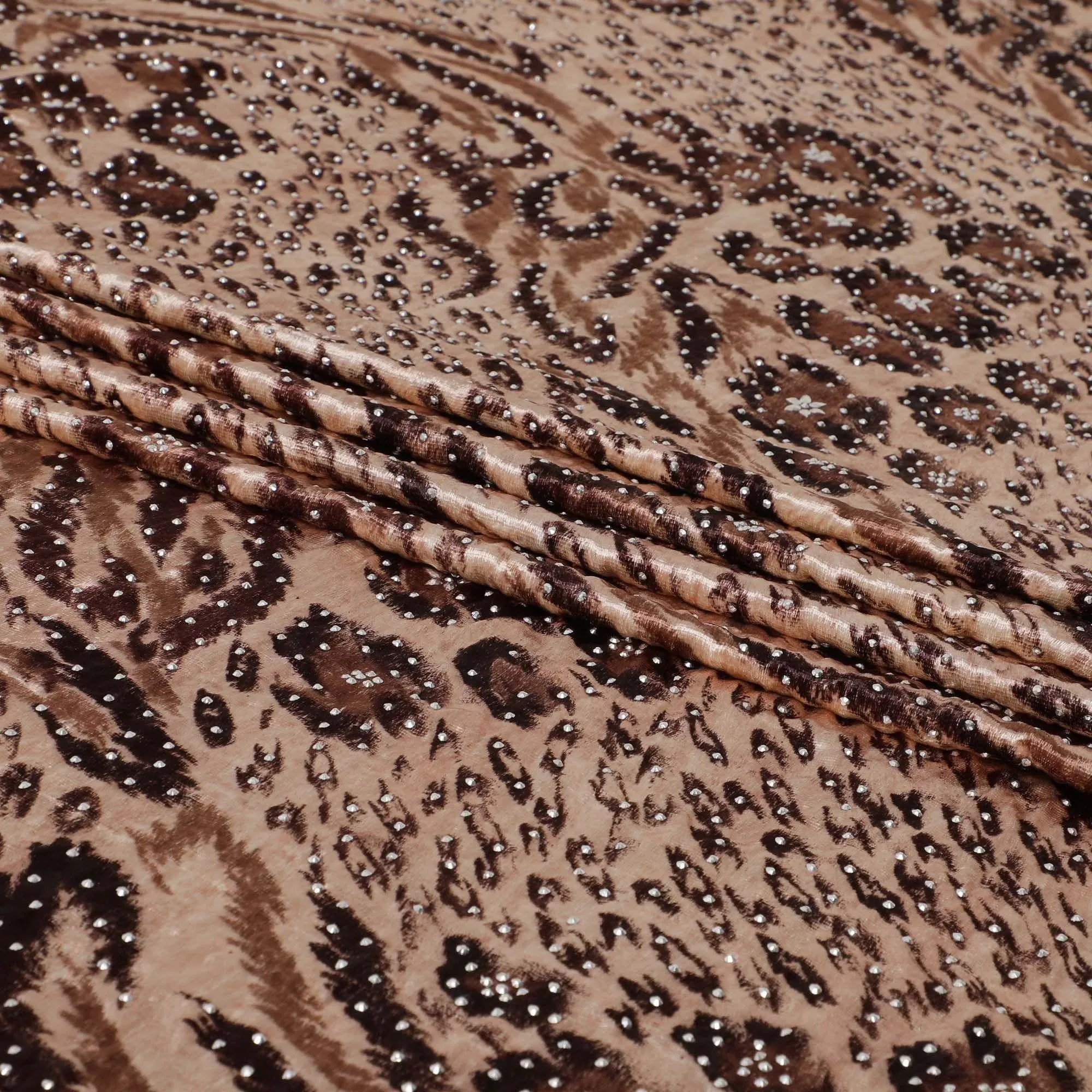 Light salmon pink Rayon velvet fabric with cocoa brown, fawn brown print having metallic silver studs in abstract design